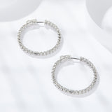 Side profile showing depth and polished edge of sterling silver circle earrings