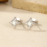 Sterling silver star studs worn on model's ear with natural lighting