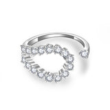 Lifestyle shot of ring on hand against soft neutral fabric backdrop