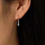 Close-up of moissanite stones set in sterling silver waterdrop frame