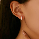 Close-up of oval moissanite stone set in sterling silver hoop