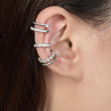Side angle showing curved ear cuff shape and sterling silver finish