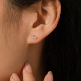 Close-up of pavé-set moissanite stones in sterling silver square frame