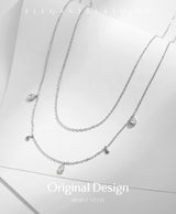 Lifestyle shot of necklace styled with minimalist outfit and natural lighting