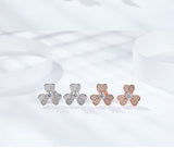 Flat lay composition with clover earrings, dried lavender sprig, and leather journal