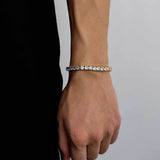 18K gold plated iced out tennis chain bracelet modeled on female wrist with black fitted top, cubic zirconia tennis bracelet for women, hip hop jewelry gift for her