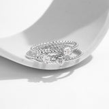 Lifestyle shot of hand wearing square moissanite ring with neutral nails