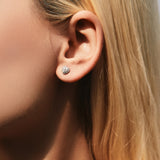 Close-up macro shot highlighting precise moissanite stone setting and polished silver prongs