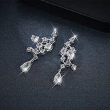 Top-down flat lay featuring earrings beside FITINY branded gift box and satin pouch