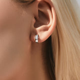 Close-up of moissanite stones sparkling on U-shaped sterling silver earrings