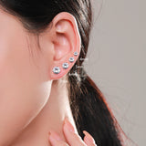 Lifestyle shot of earrings worn on earlobe with soft natural lighting
