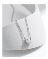 Necklace resting on open palm to emphasize lightweight, wearable design