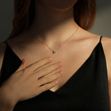 Side angle of sterling silver moissanite pendant showing four-prong setting