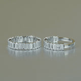 Side profile showing precise 2x4mm emerald-cut moissanite stones and smooth band contour