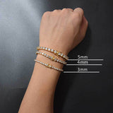 18K gold plated iced out tennis chain bracelet size comparison on wrist showing 3mm, 4mm, and 5mm widths stacked, cubic zirconia hip hop bling bracelet for everyday wear