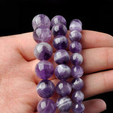 Amethyst bracelet worn on wrist with neutral sleeve, lifestyle context