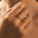 Close-up of round moissanite stones reflecting light on sterling silver ring