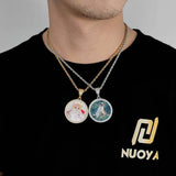Lifestyle shot of pendant necklace worn over black t-shirt with relaxed streetwear styling