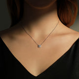 Front view of square pendant moissanite necklace on model's collarbone