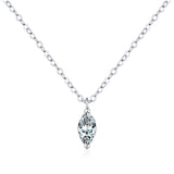 Flat lay of necklace with soft fabric backdrop highlighting geometric symmetry