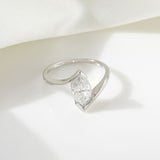 Yellow gold oval ring placed beside botanical elements for earthy contrast