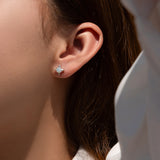 Close-up of green moissanite stone set in geometric star frame