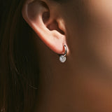 Close-up of 6mm round moissanite stone with fire and clarity detail