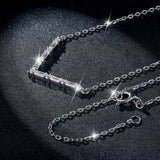 Lifestyle shot of necklace worn with a simple white blouse and blazer — office-ready styling