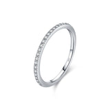 Lifestyle image of ring on wrist against neutral textured backdrop