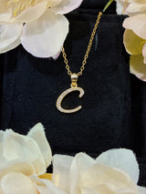 Close-up of C letter pendant highlighting polished sterling silver surface and faceted moissanite