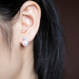 Comparison of pearl size against a US dime for scale reference