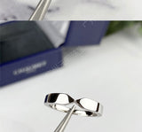 Natural light shot of rings resting on open journal page with coffee cup nearby