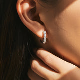 Close-up of VVS1 moissanite stones set in polished sterling silver hoop