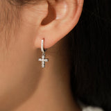 Close-up detail of hand-set moissanite stones and clean cross silhouette