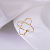 Side profile showing geometric crossover band and 0.25ct round moissanite stone