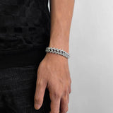 Bracelet placed on marble surface highlighting reflective properties