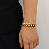 Gold 16mm Cuban link bracelet styled with casual streetwear outfit