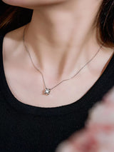 Top-down flat lay of necklace in gift-ready matte box with ribbon