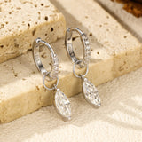 Waterdrop earrings worn on model's ear demonstrating elegant dangle and proportion