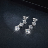 Top-down flat lay of earrings beside FITINY branded packaging and soft velvet insert