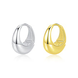 Gold-plated version of liquid metal hoop earrings displayed on velvet ring holder