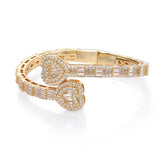 Close-up detail of sparkling zirconia stones set in heart motif on gold-plated bracelet