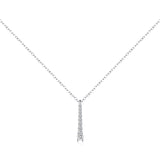 Top-down flat lay with necklace arranged in elegant curve beside vintage book and coffee cup