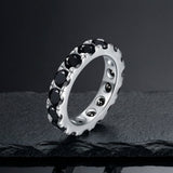 Black moissanite eternity stack ring in S925 sterling silver on dark slate