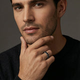 Male model wearing black moissanite stack ring — editorial portrait