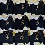Flat lay of three alphabet pendants (A, M, Z) showing variety and consistency