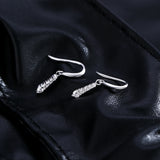 Lifestyle image: earrings worn with a silk blouse and minimal makeup