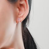 Close-up detail of freshwater pearl set in polished sterling silver hoop