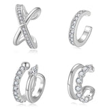 Flat lay of all four ear cuff designs arranged in a modern jewelry display