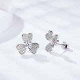 Close-up of 0.30 carat moissanite stone set in clover-shaped white gold plated earring